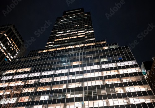 modern office building in new york manhattan office work corporate night photography finance financial center wall street windows stock value brocker law consultant photo