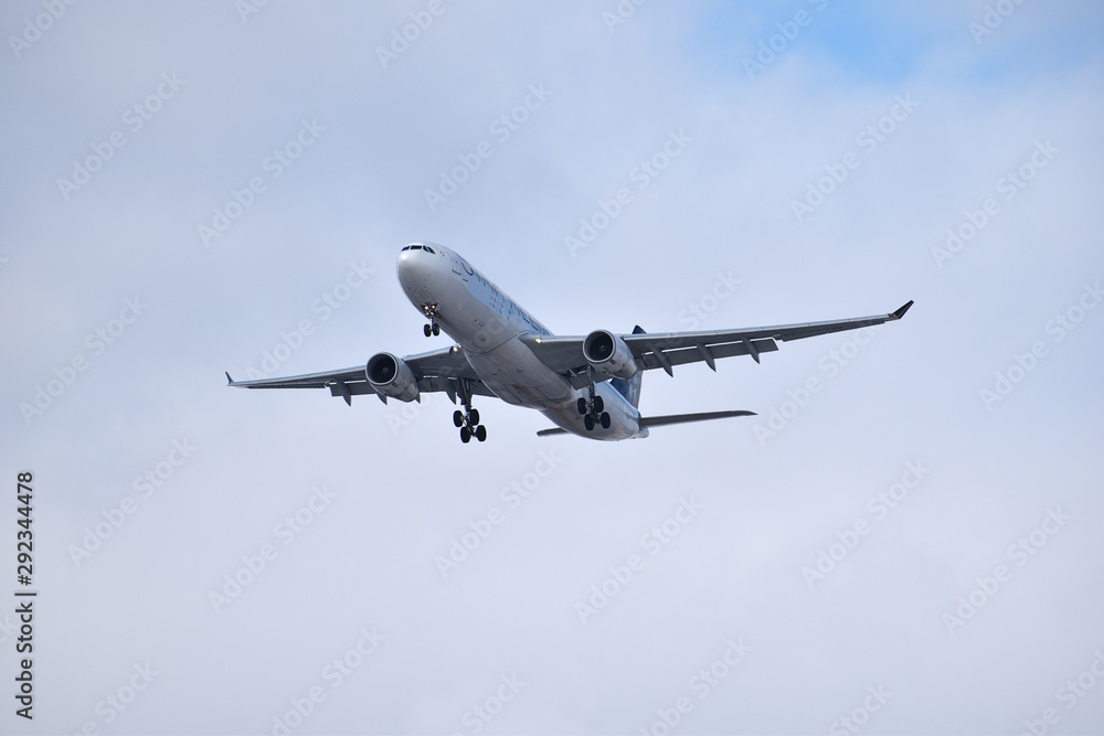 Landing jet  under clouds