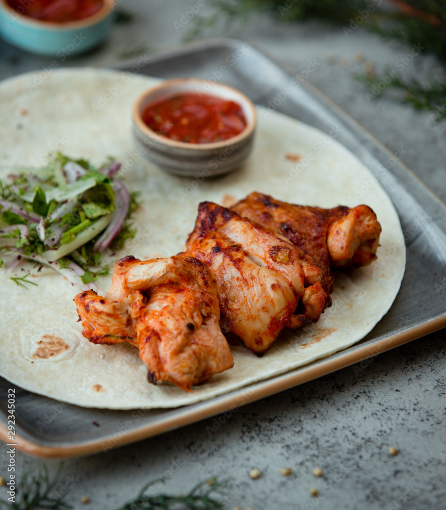 Grilled chicken kebab in the wrap with salad Grilled chicken kebab in the wrap with salad
