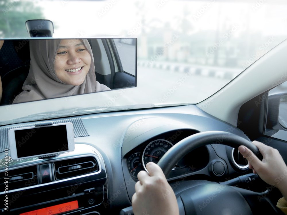Fototapeta premium Smiling Muslim Lady Driving a Car