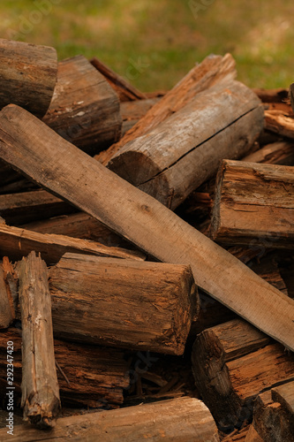 Dry chopped firewood logs in a pile. A pile of old wood from house building. Wood recycling. Eco environment concept.