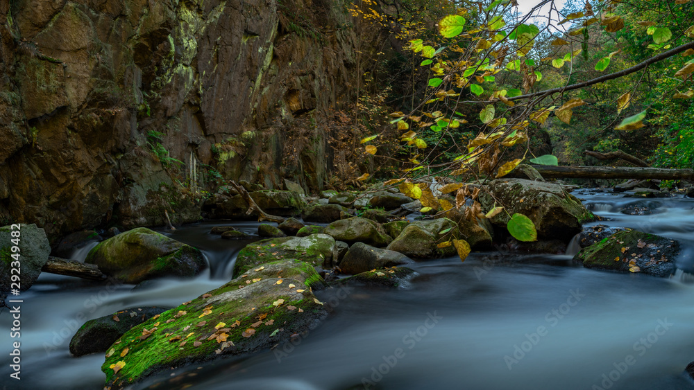 Waterfall with colorful leaves and green moss in autumn. Germany in the Bode Valley Waterfall with colorful leaves and green moss in autumn. Germany in the Bode Valley