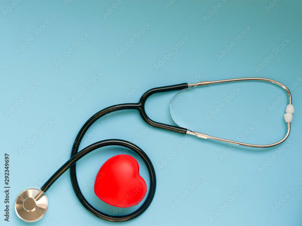 Red heart with doctor's stethoscope on blue background and copy space, healthcare medical concept Red heart with doctor's stethoscope on blue background and copy space, healthcare medical concept