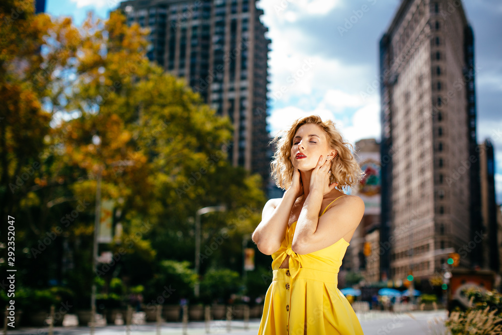 Woman in yellow dress enjoying the sun in New York