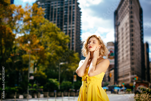 Woman in yellow dress enjoying the sun in New York
