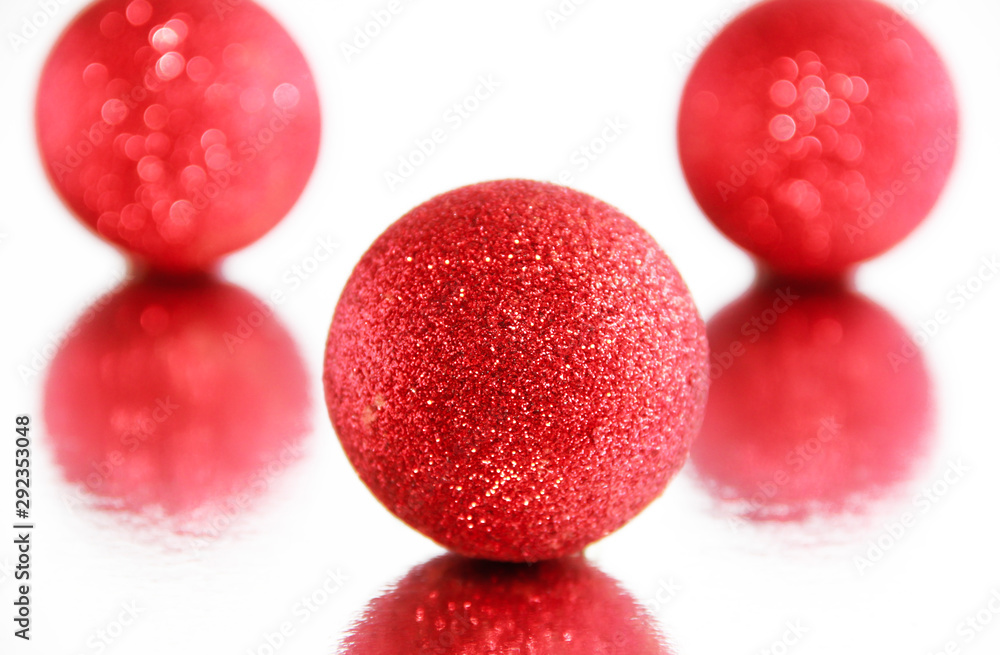 red shiny christmas toys balls on a mirror background with reflection red shiny christmas toys balls on a mirror background with reflection