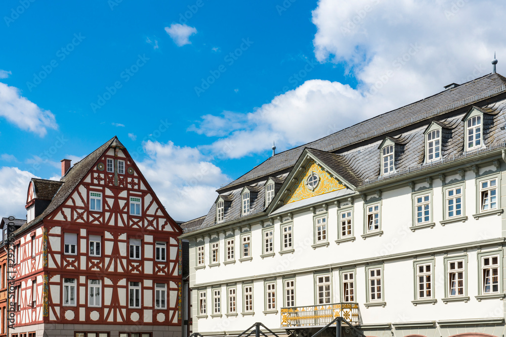 white building with balcony and red half timbered house in Limburg an der Lahn, Germany