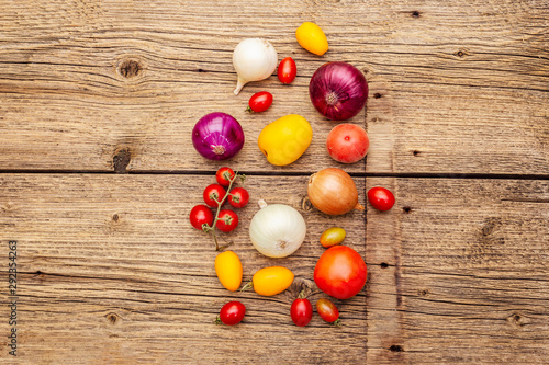 Autumn harvest vegetables cooking background. Assortment of different types onions and tomatoes