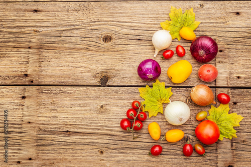 Autumn harvest vegetables cooking background. Assortment of different types onions and tomatoes