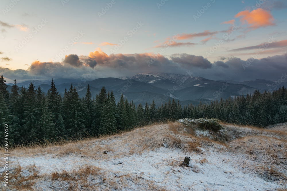 Fabulous Carpathian Mountains in the cold season with fantastic sky and clouds