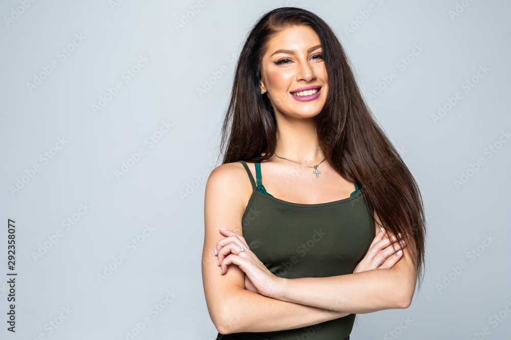 Portrait of a happy woman standing with arms folded isolated on white background Portrait of a happy woman standing with arms folded isolated on white background
