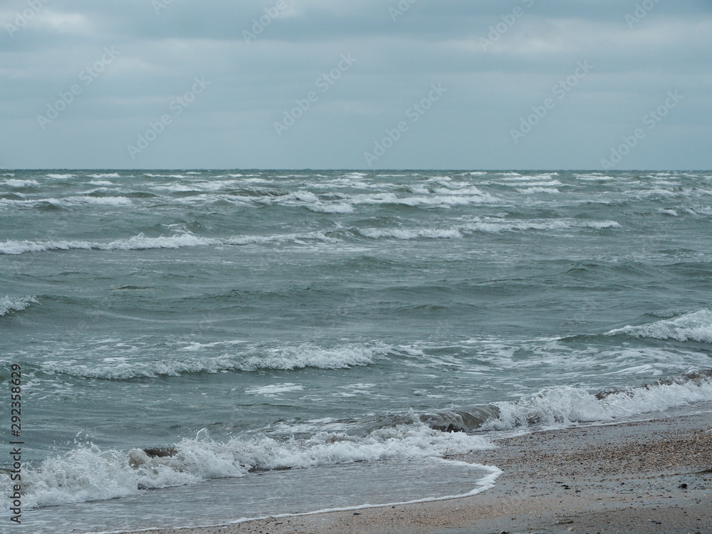 Waves of stormy sea rolled on beach