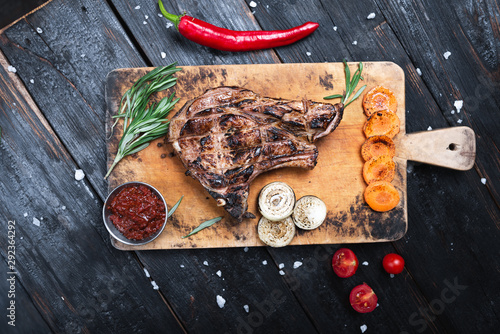 medium-sized steak on a cutting board, juicy grilled meat.