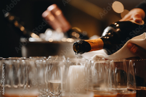 Canvas Print Pouring champagne into wine glasses