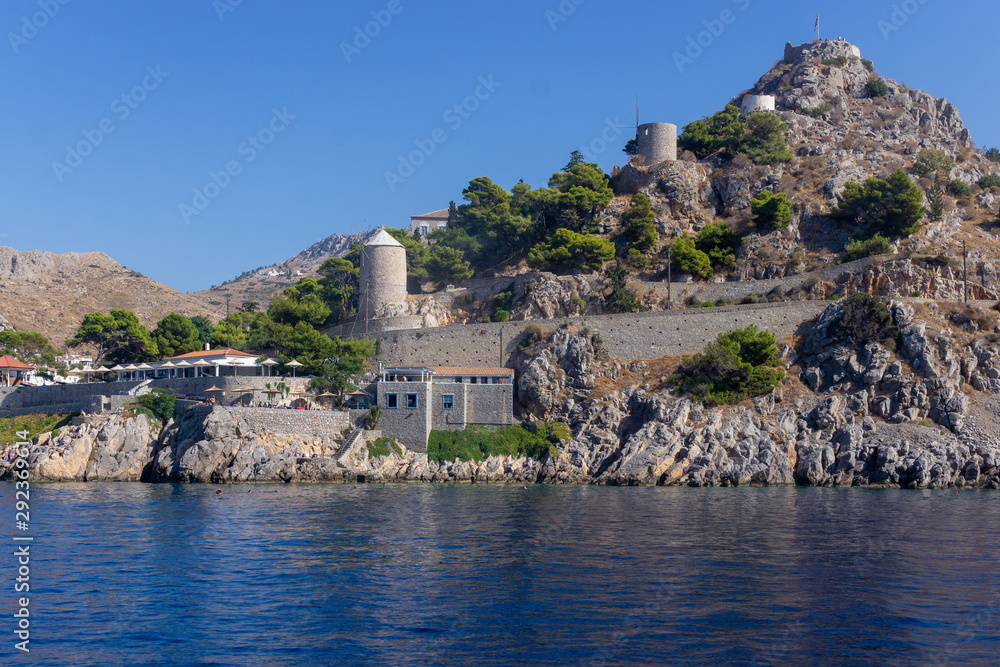 Obraz premium Hydra Island port view in Greece - Wind mills and towers