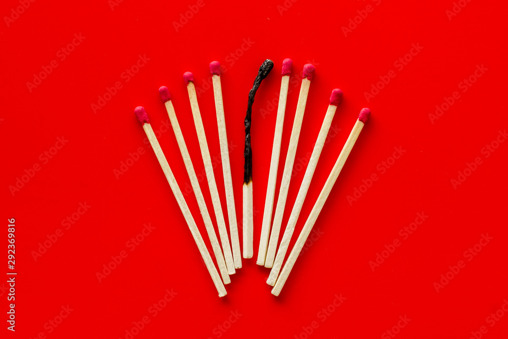 Matches for danger concept on red background top view Matches for danger concept on red background top view