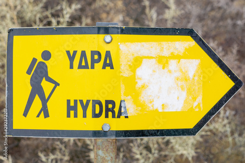 Fototapeta Naklejka Na Ścianę i Meble -  Yellow hike sign toward Hydra - mountain path. Greece Island