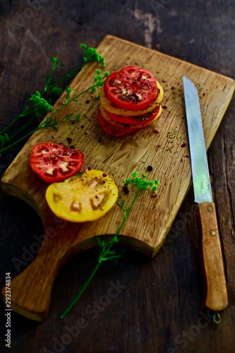 red tomato on the wood plate