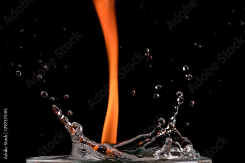 burning drink, splash and fire on a black background