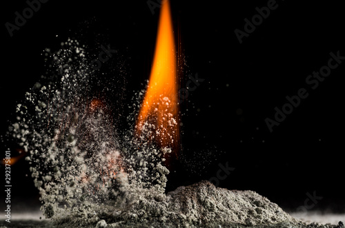 burning sand and a splash of water on a black background  the fifth element