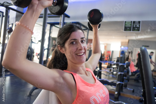 woman training in gym with weights
