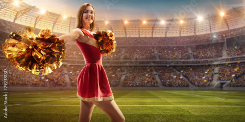 A cheerleader in action on the professional stadium. Stadium and crowd are made in 3d. photo