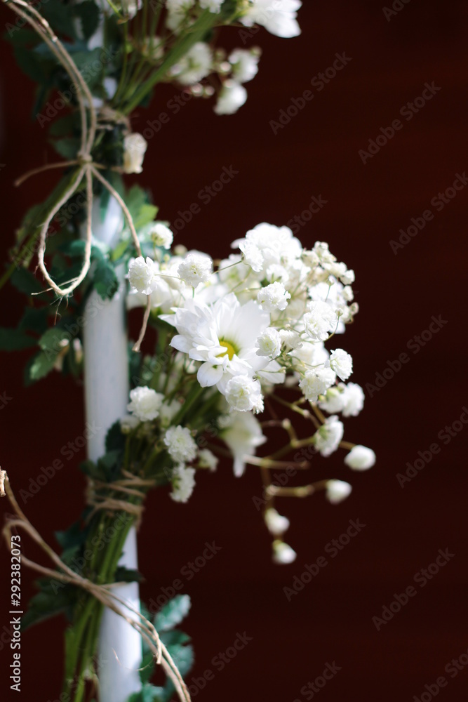 Decoration of white flowers. A small bouquet of white flowers, street decoration. Wedding decorations on the street.