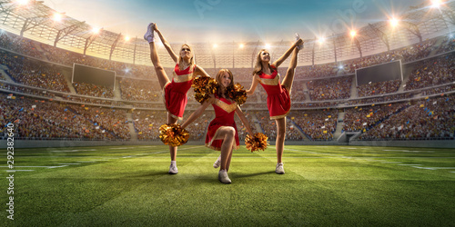 Group of cheerleaders in action on the professional stadium. The stadium and crowd are made in 3d photo