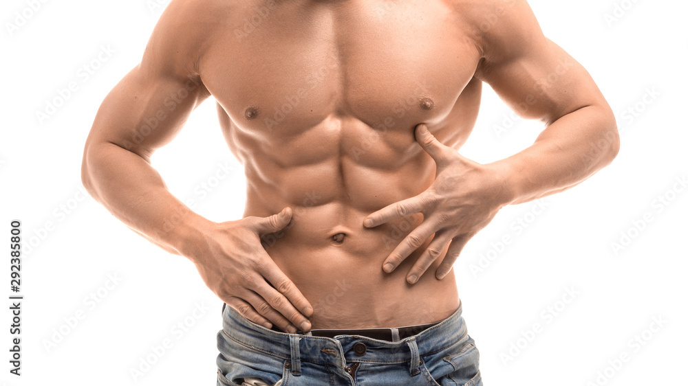 Healthy muscular young man touchig his ABS