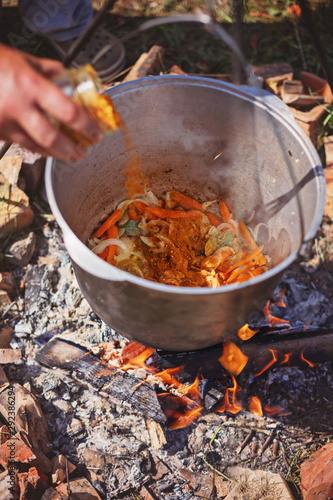 Cooking outdoors in cast iron cauldron on a campfire