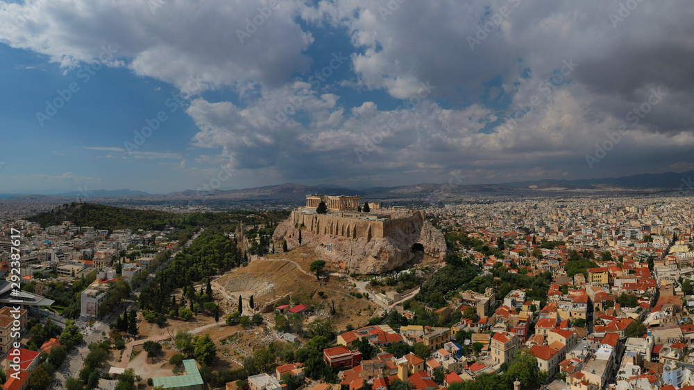 Aerial photo of unique Masterpiece of Ancient times the Parthenon on top of iconic Acropolis hill with beautiful clouds and blue sky, Athens, Attica, Greece
