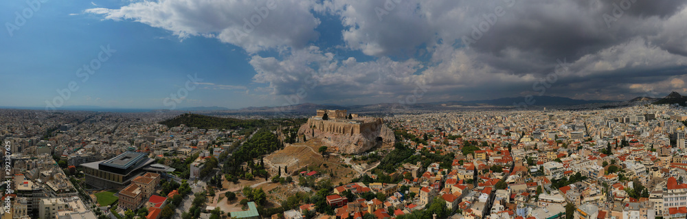 Aerial photo of unique Masterpiece of Ancient times the Parthenon on top of iconic Acropolis hill with beautiful clouds and blue sky, Athens, Attica, Greece