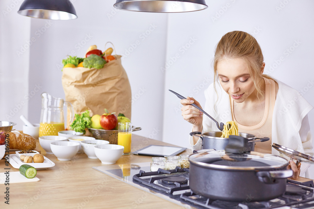 Young Woman Cooking in the kitchen. Healthy Food