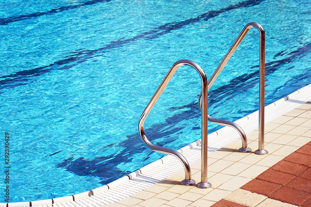 Handrails for descent into the pool. Pool cleaner during his work