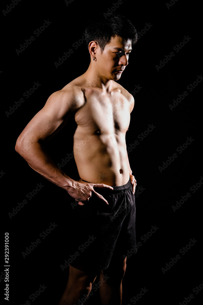 Fototapeta premium athletic muscular bodybuilder man with naked torso six pack abs. fitness workout concept