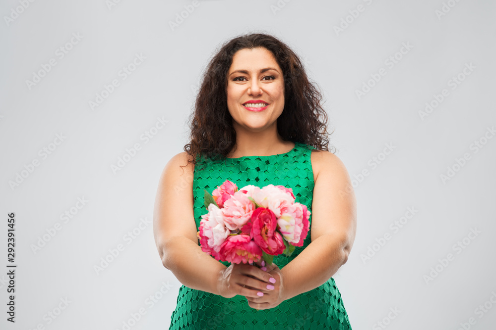 people and portrait concept - happy woman in green dress with flower bunch over grey background people and portrait concept - happy woman in green dress with flower bunch over grey background