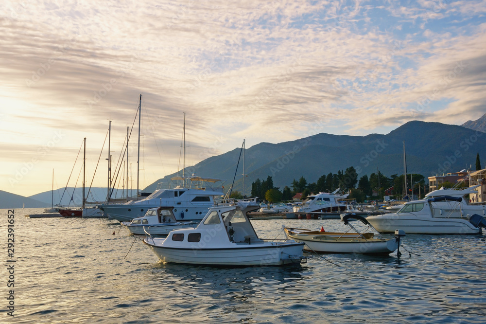 Fototapeta premium Beautiful evening Mediterranean landscape with fishing boats on water. Montenegro, Adriatic Sea, view of Bay of Kotor near Tivat city in autumn
