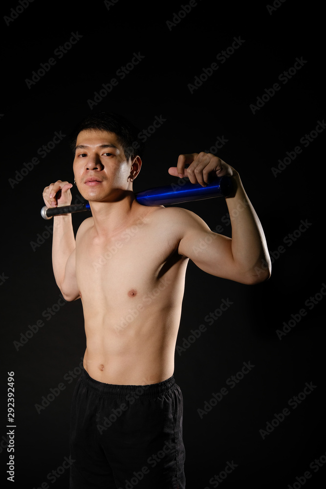 athletic muscular bodybuilder man with naked torso six pack abs holding baseball bat. fitness workout concept athletic muscular bodybuilder man with naked torso six pack abs holding baseball bat. fitness workout concept