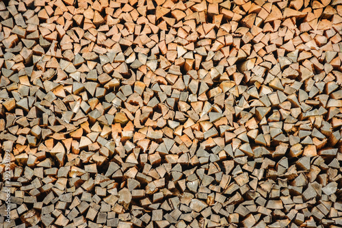 Array of firewood stacked in a woodpile.