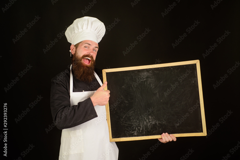 Advertisement. Happy chef hold blackboard. Man cook show empty menu chalkboard with copy space. Smiling chef, cook or baker with blank board. Empty menu chalkboard with copy space for text. Chef menu.