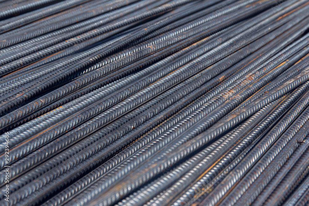 Industrial background. Brand new steel rebars at a construction site. Preparation for pouring concrete. Construction of buildings of reinforced concrete.