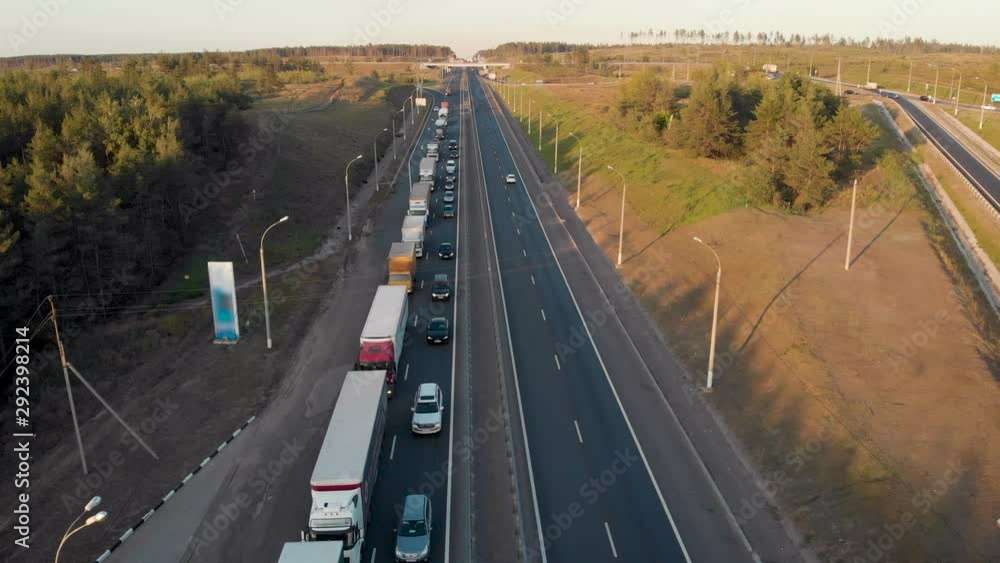 aerial view. Intercity highway section. Congestion on the road. Cars and wagons are standing in a long traffic jam. Slow moving vehicle. aerial view. Intercity highway section. Congestion on the road. Cars and wagons are standing in a long traffic jam. Slow moving vehicle.