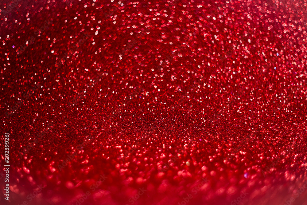Red defocused glitter background with bokeh copy space