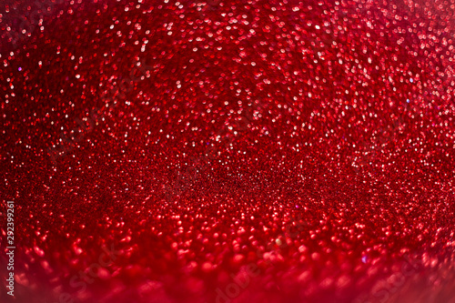 Red defocused glitter background with bokeh copy space