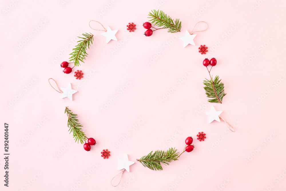 Flat lay christmas frame with spruce branches and christmas decorations on a color background