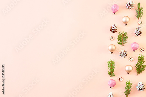 Fototapeta Naklejka Na Ścianę i Meble -  Flat lay christmas border with spruce branches and christmas decorations on a color background