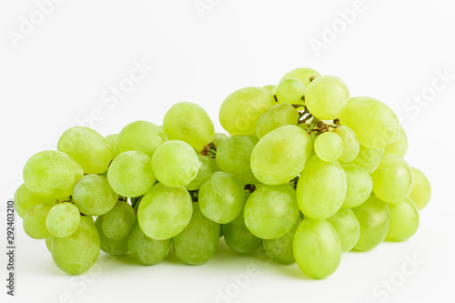 One bunch of ripe organic white grapes isolated on white background, side view