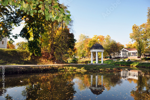 Autumn landscape of the lake surrounded by a city Park.