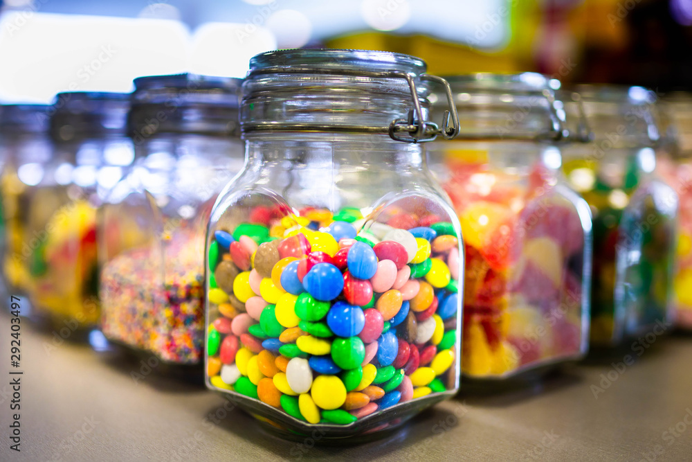 Sweets in glass jars. A large number of multi-colored sweets in banks Sweets in glass jars. A large number of multi-colored sweets in banks