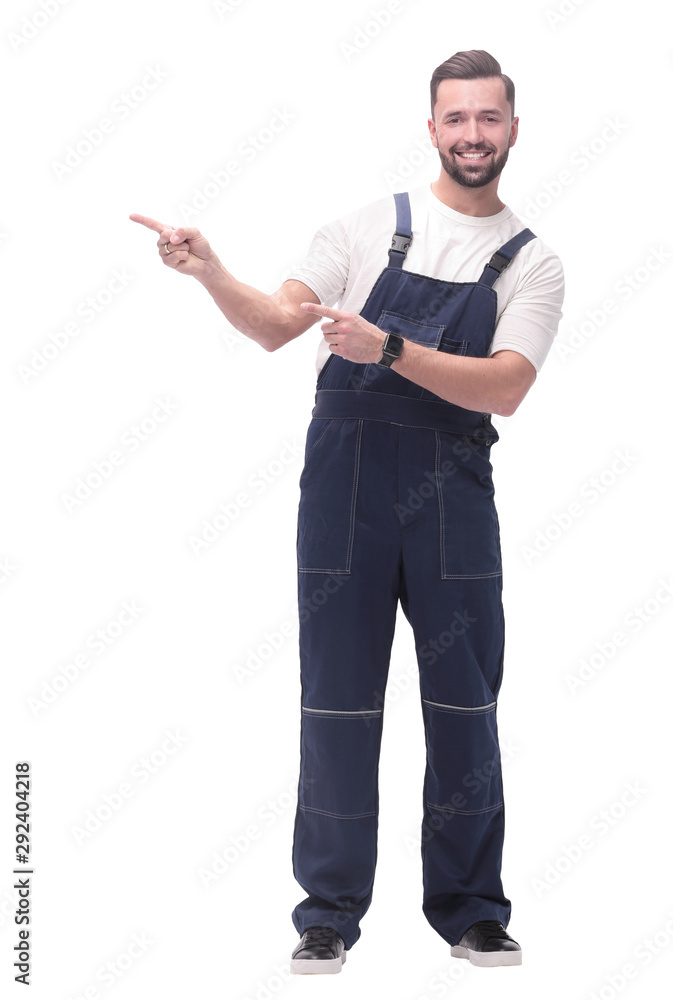smiling man in overalls pointing to a copy of the space smiling man in overalls pointing to a copy of the space